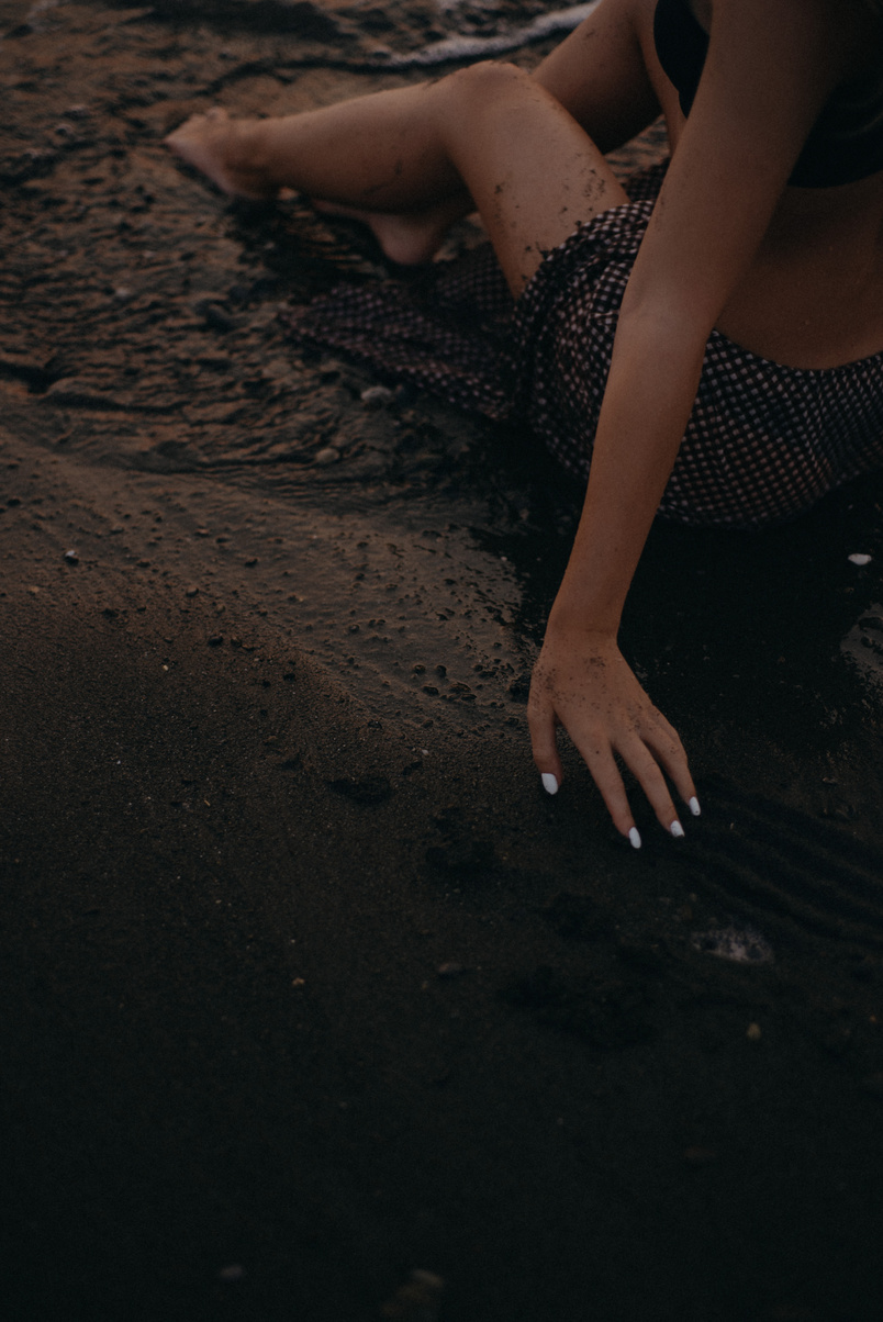 Woman in Black and White Polka Dot Bikini Lying on Sand