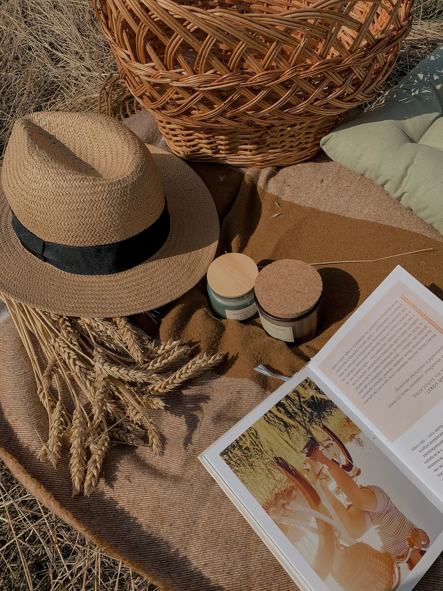 Brown Straw Hat, Glass Jars and an Open Book on a Picnic Blanket
